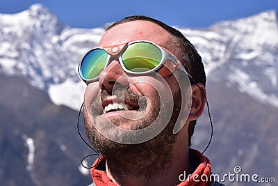 Alpinist looking at summit, mountain background Stock Photo