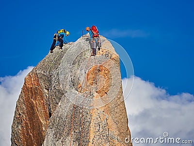 AIGUILLE DU MIDI, FRANCE - AUGUST 8, 2017: Alpinists climbing on rocks at Aiguille du Midi, Chamonix, France Editorial Stock Photo
