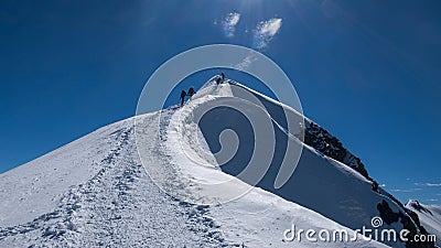 Alpinists climbing up to Mont Blanc. Stock Photo