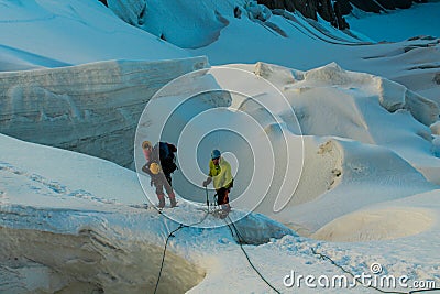 Alpinists on the glacier at high altitude snow mountains Editorial Stock Photo