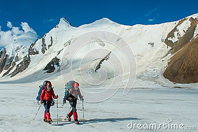 Alpinists on the glacier at high altitude snow mountains Editorial Stock Photo