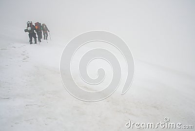 Alpinists and stormy weather Stock Photo