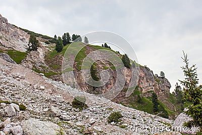 Alpinists walking on path upon Dibona section, an important geologic site of Tofana Mountain Group Stock Photo