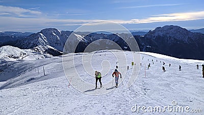 on alps hikers walk on snow to reach snowy peak of mountain top in Italy Editorial Stock Photo