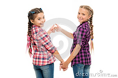 Alright thumb up. Fashionable cutie. Happy childhood. Keep hair braided. Sisters with long braided hair. Hairdresser Stock Photo