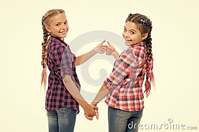 Alright thumb up. Fashionable cutie. Happy childhood. Keep hair braided. Sisters with long braided hair. Hairdresser Stock Photo