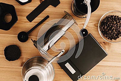 Alternative coffee brewing method, flat lay. Stylish accessories and items for alternative coffee on wooden table. Steel kettle, Stock Photo