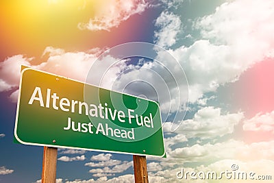 Alternative Fuel Green Road Sign Against Cloudy Sky Stock Photo