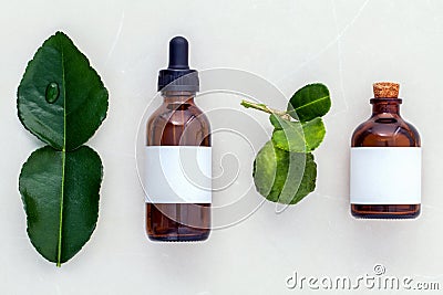 Alternative health care fresh kaffir llime leaves and oils on m Stock Photo