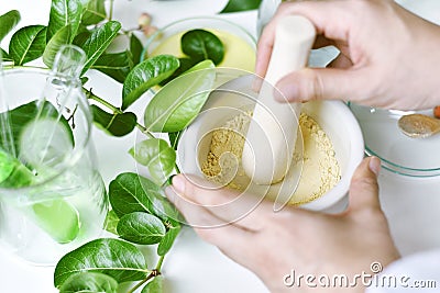 Alternative herbal medicine, Mortar with healing botanical herbs, Natural organic botany and scientific glassware. Stock Photo