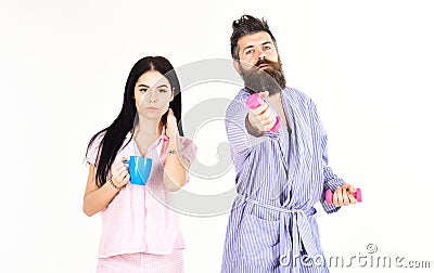 Alternative lifestyle concept. Couple, family offers alternative energy source. Couple in love in pajama, bathrobe stand Stock Photo