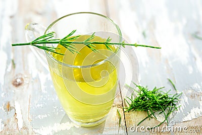 Alternative Medicine. Herbal Therapy. Horsetail infusion in glass cup. grey background Stock Photo