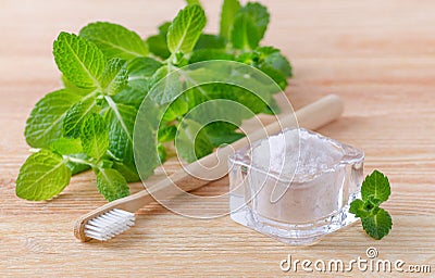 Alternative natural toothpaste himalayan salt and wood toothbrush, mint on wooden Stock Photo