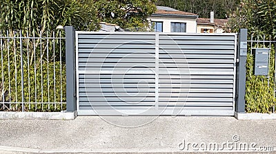 Aluminium sliding modern home gray steel gate portal of suburb house Stock Photo