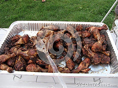 An Aluminum Pan Filled With Grilled Chicken Legs Stock Photo