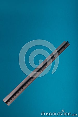 aluminum ruler on blue background Stock Photo