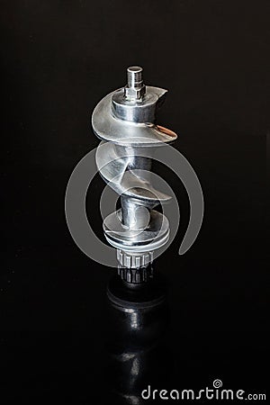 Aluminum meat grinder screw on black background Stock Photo