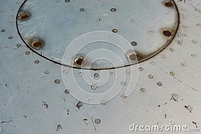 Aluminum surface of the aircraft fuselage. Smooth rows of rivets, there are scratches, dirt Stock Photo