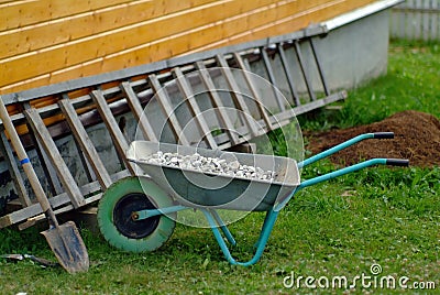 Aluminum trolley with crushed stone in the village Stock Photo