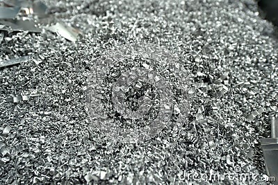 Aluminum waste resulting from pieces of aluminum metal being processed by cutting, cnc processing. Stock Photo