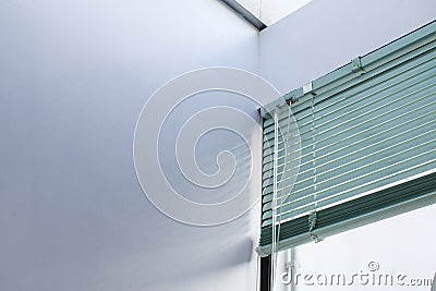 Aluminum window rolling blind. White plastic window with blinds close-up. Stock Photo