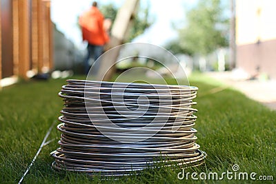 Aluminum wire coil on the grass Stock Photo