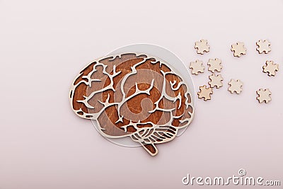 Alzheimer's disease and mental health concept. Brain and wooden puzzle on a desk Stock Photo