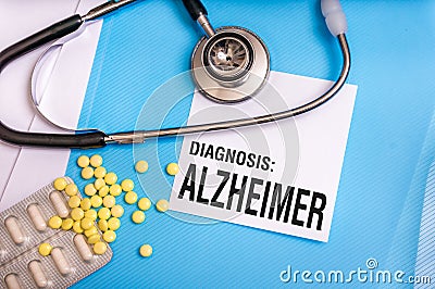 Alzheimer word written on medical blue folder with patient files Stock Photo