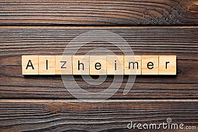 Alzheimer word written on wood block. Alzheimer text on wooden table for your desing, concept Stock Photo