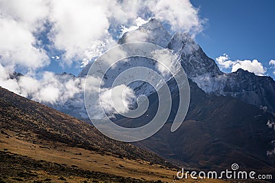Ama Dablam mountain peak behind trekkers in Everest region trekking, Nepal Stock Photo