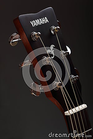 Amaha classic six-stringed wooden acoustic guitar head with metal tuning pegs Editorial Stock Photo