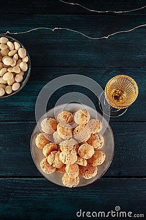 Amaretti, traditional Italian almond cookies, with a glass of Amaretto liqueur, overhead shot Stock Photo