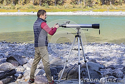 Amateur astronomer adjusts optical magnifier for viewing at sky with telescope,selective focus Stock Photo