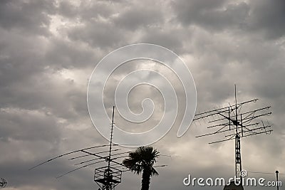 Amateur radio antennas above the roofs of houses. Stock Photo