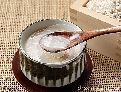 Amazake and a wooden spoon on the table Stock Photo