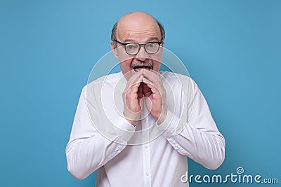 Amazed afraid senior man is shocked with news having stupor. Stock Photo