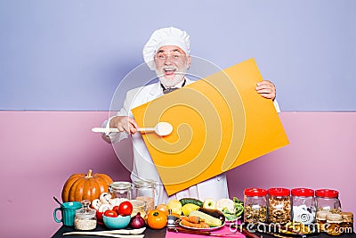 Amazed chef pointing spoon on blank board menu. Cooking, profession, advertisement and people concept. Menu blackboard Stock Photo