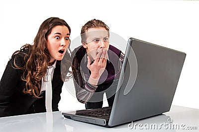 Amazed couple on line with a laptop Stock Photo