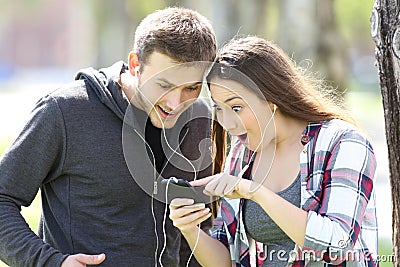 Amazed couple listening music on line Stock Photo