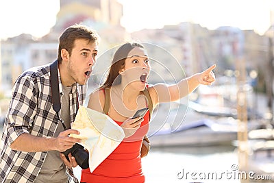 Amazed couple of tourists finding destination Stock Photo