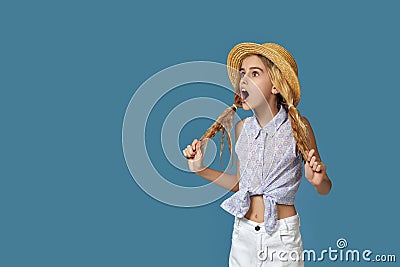 amazed cute little girl with curly hair looking at empty place Stock Photo