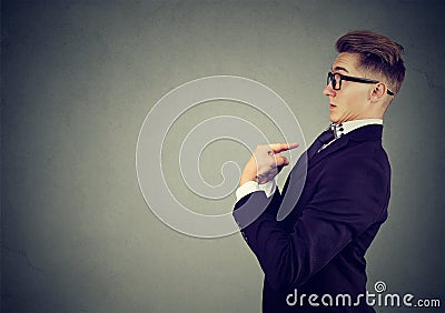 Surprised man pointing fingers at himself denies responsibility and accusations Stock Photo