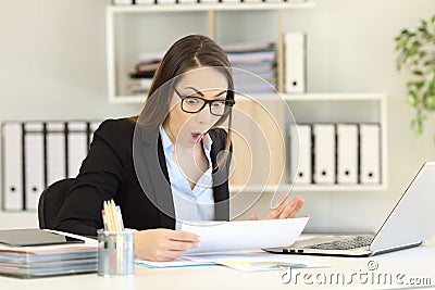 Amazed office worker reading sales report Stock Photo