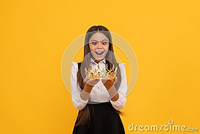 amazed schoolgirl in crown. self confident queen kid. expressing smug. arrogant princess Stock Photo