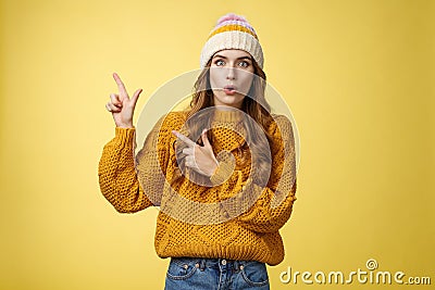 Amazed speechless stunned cute fashionable girl fold lips say wow widen eyes surprised impressed pointing upper left Stock Photo