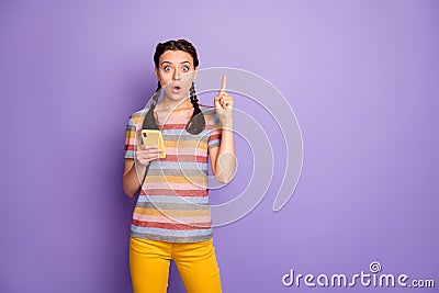 Amazed teenager millennial girl use smartphone get idea what post social media network raise index finger scream Stock Photo