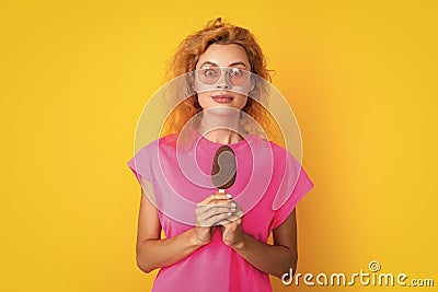 amazed woman with icelolly ice cream isolated on yellow. woman with icelolly ice cream in studio. woman with icelolly Stock Photo