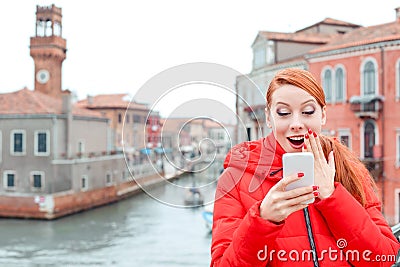 Amazed woman receiving shocking news on a smart phone Stock Photo