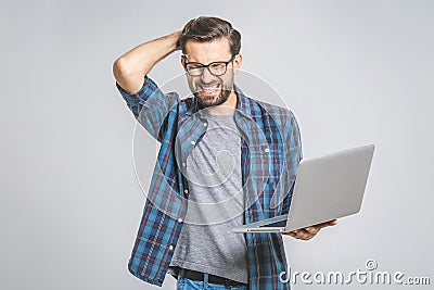 An amazed young man has got a software error. Isolated on grey background Stock Photo