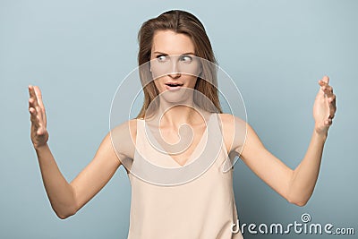 Amazed young woman show large scale measurement with hands Stock Photo